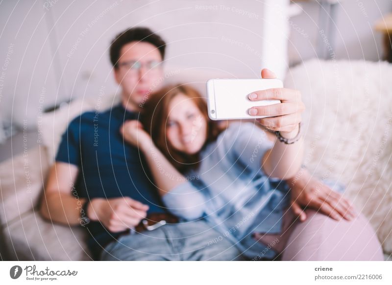 Couple taking selfie with phone at home Joy Happy Telephone Technology Human being Youth (Young adults) Adults Laughter Embrace Together Romance Relationship
