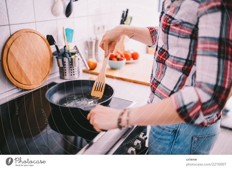 Close-up of woman cooking in the kitchen Diet Pan Lifestyle Leisure and hobbies Kitchen Feminine Woman Adults Hot Bright Food stove chef Frying Indoor People