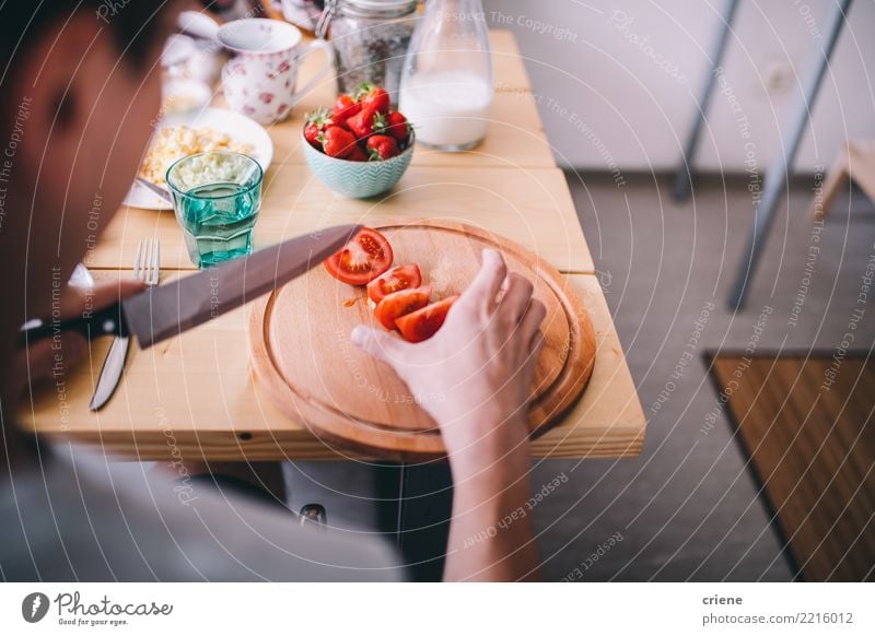 Man cutting tomatoes at breakfast table in the morning Vegetable Eating Breakfast Diet Healthy Eating House (Residential Structure) Table Kitchen Adults