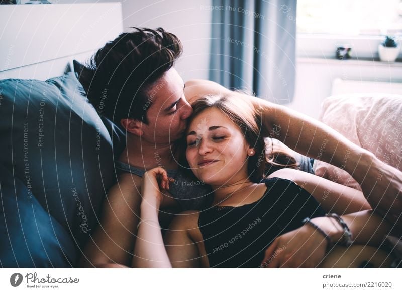Boyfriend giving his girlfriend a kiss in the bed Joy Happy Relaxation Leisure and hobbies House (Residential Structure) Living room Bedroom Woman Adults Man