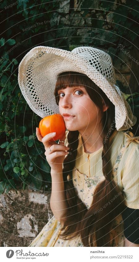 Young and old fashioned woman holding a persimmon Food Vegetable Fruit Orange Nutrition Eating Lifestyle Style Beautiful Healthy Healthy Eating Wellness