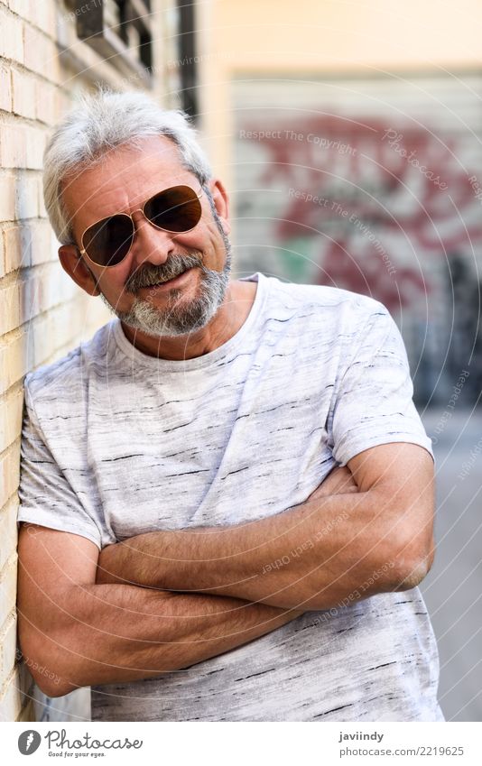 Mature man smiling at camera in urban background Lifestyle Happy Human being Man Adults Male senior 45 - 60 years Street Clothing Sunglasses Beard Old Smiling