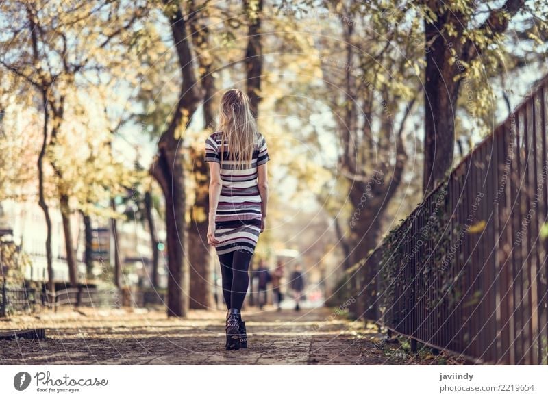 Rear view of young blonde woman walking in the street. Lifestyle Elegant Style Beautiful Hair and hairstyles Human being Feminine Young woman