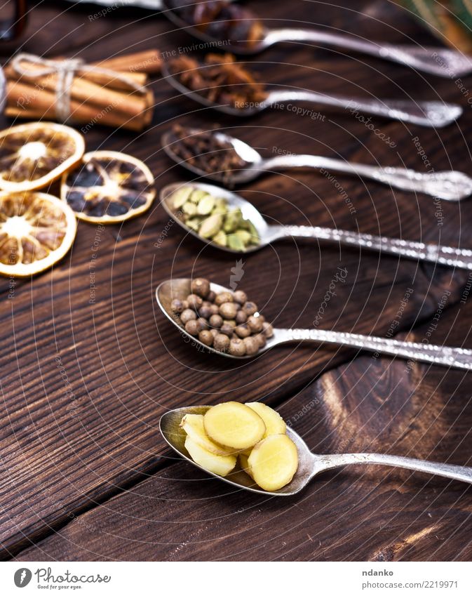 sliced ginger in an iron spoon Herbs and spices Spoon Brown Cardamom Cinnamon wood dry Clove orange food allspice star anise Colour photo Close-up Deserted