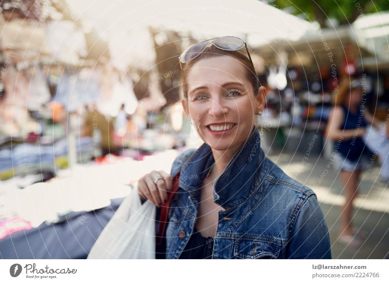 Happy woman shopping at an outdoor market Shopping Face Leisure and hobbies Vacation & Travel Tourism Summer Woman Adults 1 Human being 30 - 45 years Warmth