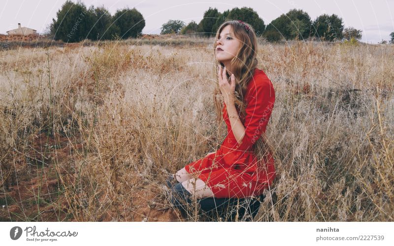 Young blonde woman wearing a red dress is waiting in a field Lifestyle Elegant Style Beautiful Harmonious Well-being Vacation & Travel Human being Feminine