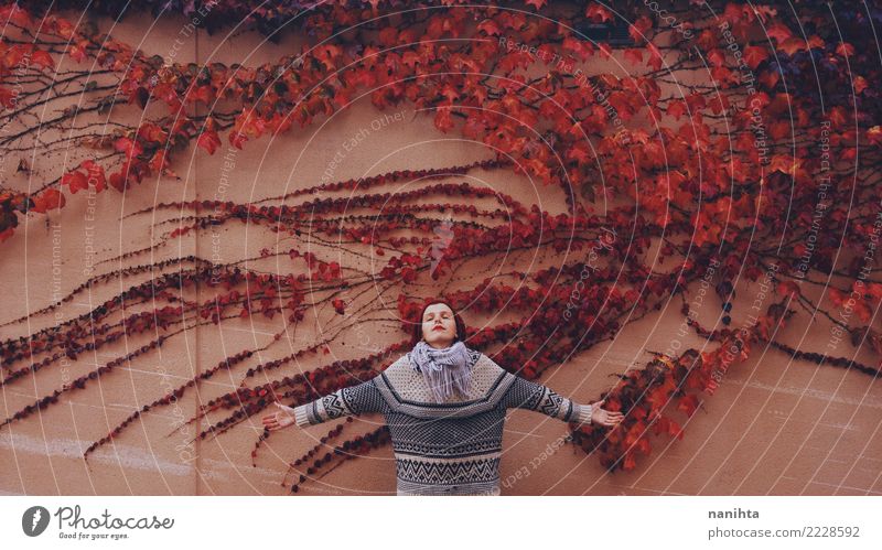 Young woman in a wall full of autumn leaves Design Wellness Harmonious Relaxation Human being Feminine Woman Adults Youth (Young adults) 1 18 - 30 years Nature