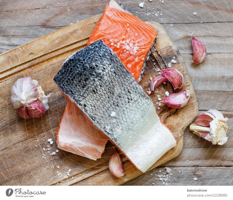 Fresh raw salmon on a wooden cutting board Seafood Vegetable Nutrition Eating Dinner Diet Table Above Red background cooking fillet fish healthy Ingredients