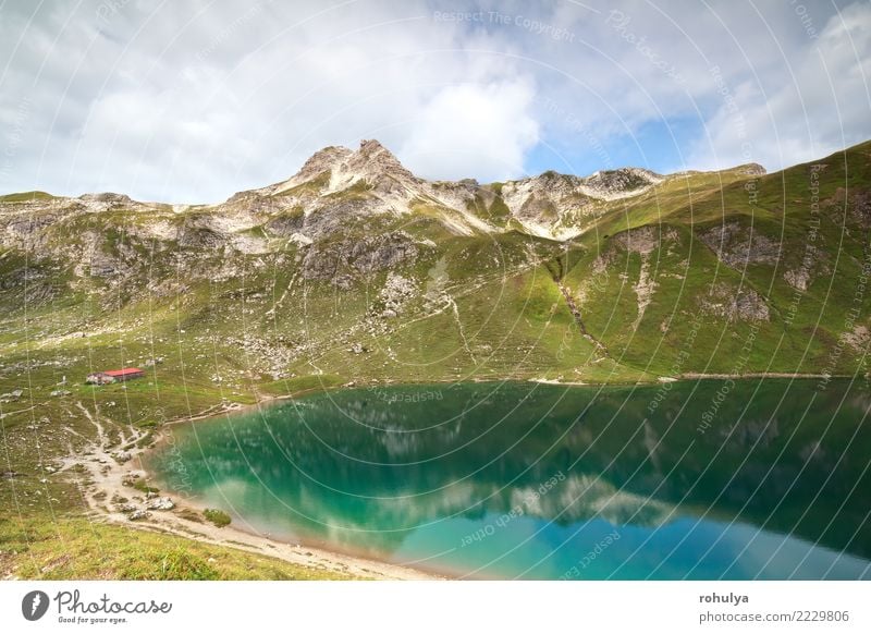 cabin by turquoise alpine lake in mountains Vacation & Travel Mountain House (Residential Structure) Nature Landscape Sky Clouds Summer Beautiful weather Alps