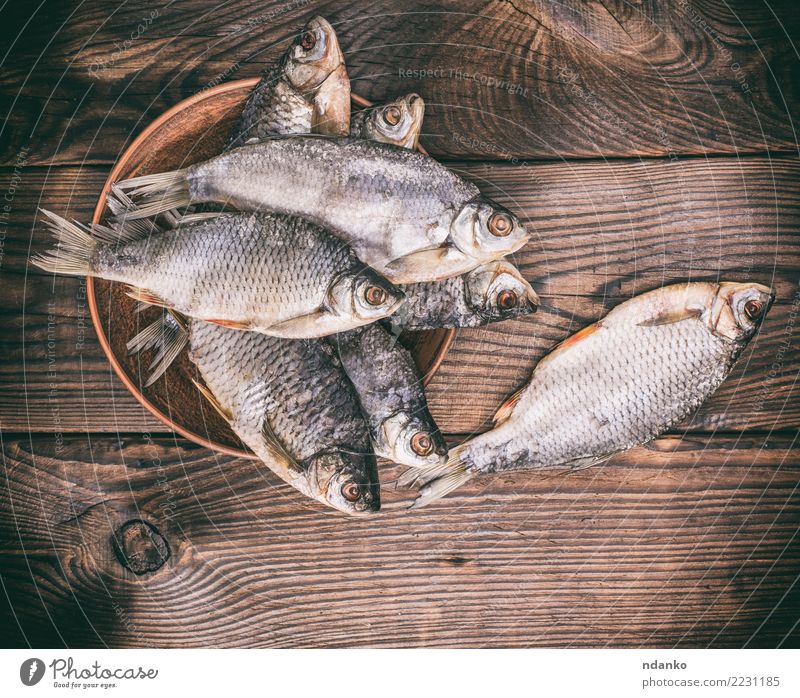 fish ramming in scales Fish Seafood Plate Group Animal Wood Eating Natural Above Brown Roach salted background dry Preparation Snack Gourmet board appetizer