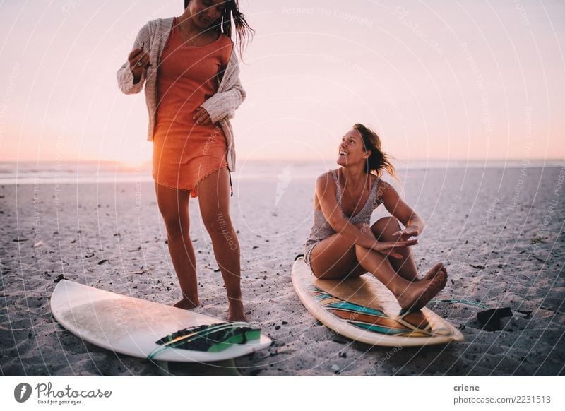 Two happy girlfriends having fun at the beach with surfboards Lifestyle Joy Happy Relaxation Leisure and hobbies Vacation & Travel Summer Beach Feminine Woman