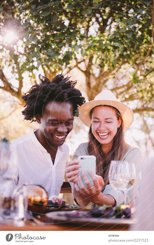 Happy Young adult couple watching videos on phone Lifestyle Joy Summer Table Restaurant Telephone Technology Couple Adults Afro Smiling Together Bright Emotions