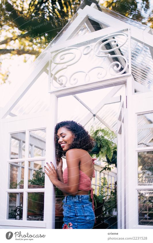 Portrait of smiling young african woman in greenhouse Joy Happy Woman Adults Smiling Tropical Greenhouse african ethnicity positive Colour photo Exterior shot