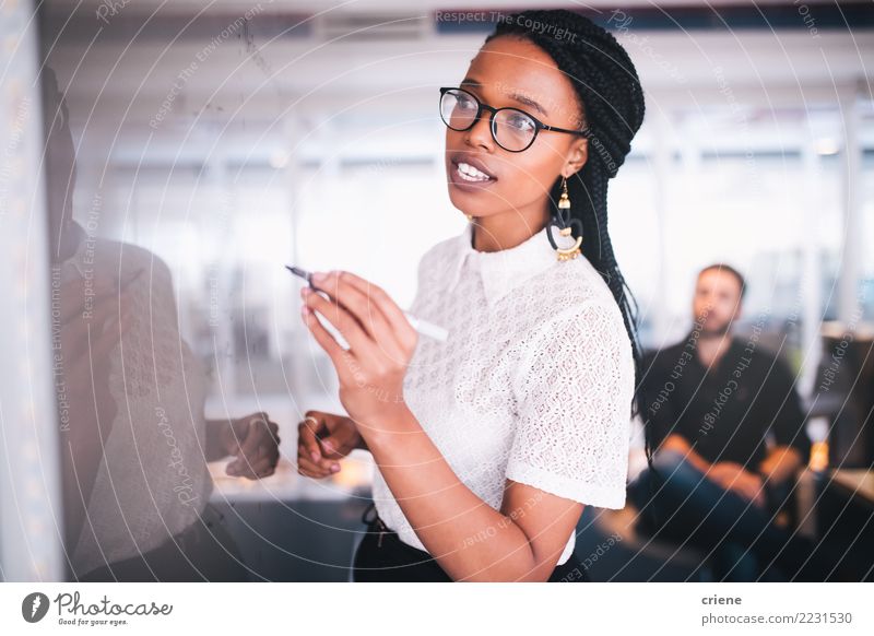 Young african businesswoman writing notes on whiteboard Success Internship Work and employment Office Financial Industry Business Meeting To talk Human being