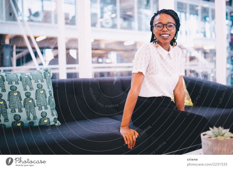 Portrait of smiling young african businesswoman in office Happy Success Work and employment Office Business Adults Afro Smiling Emotions Self-confident