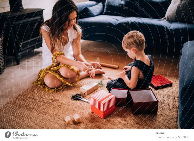 Young family wrapping Christmas gifts at home Joy Happy Winter Living room Christmas & Advent Parenting Child Craft (trade) Toddler Parents Adults Mother