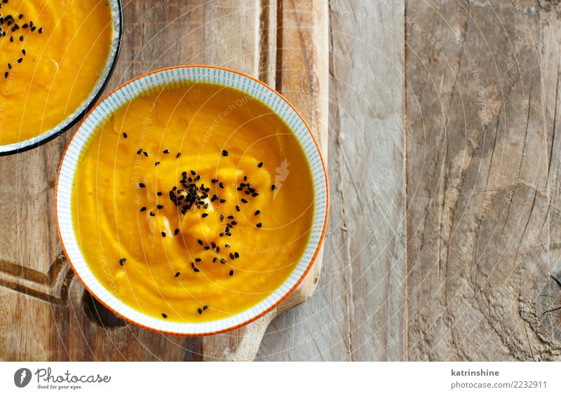 Fresh pumpkin soup in two bowls on a wooden table Vegetable Soup Stew Vegetarian diet Bowl Table Thanksgiving Hallowe'en Autumn Delicious Yellow Colour fall