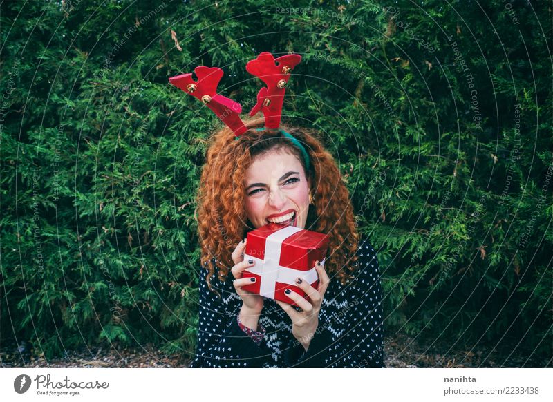 Young woman eating a christmas gift Lifestyle Joy Beautiful Feasts & Celebrations Christmas & Advent New Year's Eve Human being Feminine Youth (Young adults) 1