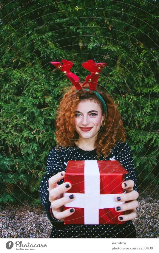 Young woman holding a christmas gift box Lifestyle Shopping Style Joy Beautiful Feasts & Celebrations Christmas & Advent New Year's Eve Human being Feminine