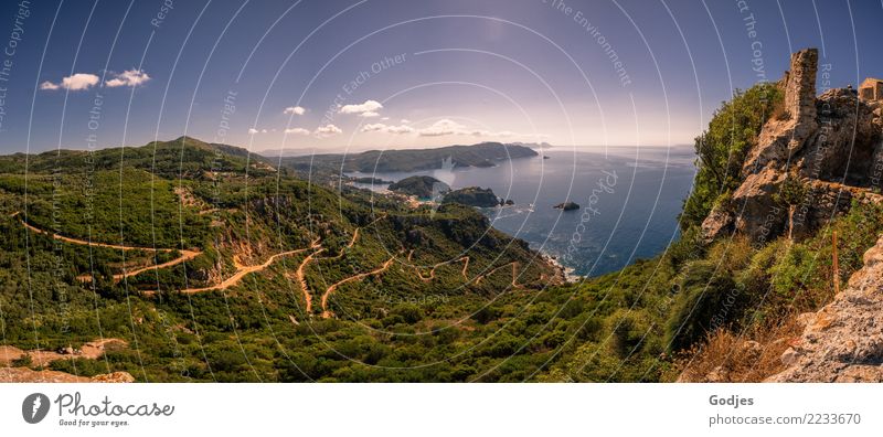 Nature panorama with a view of the Mediterranean Sea, a winding road and the ruins of Paleokastritsa Castle | Paleokastritsa Landscape Water Sky Clouds Horizon