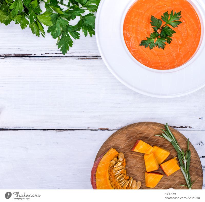 pumpkin soup in a white plate Vegetable Soup Stew Herbs and spices Nutrition Eating Lunch Dinner Vegetarian diet Diet Plate Table Kitchen Hallowe'en Wood Fresh