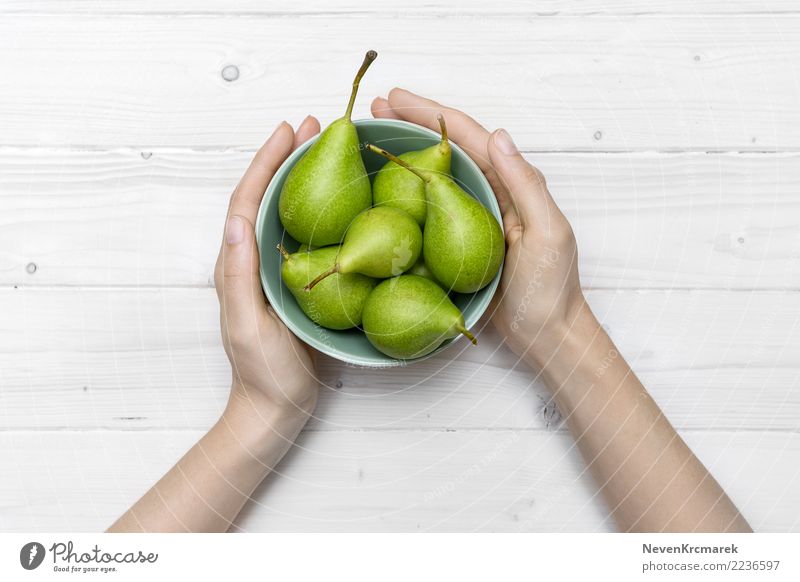 Female hands holding a bowl of green pears Food Fruit Pear Nutrition Eating Breakfast Lunch Dinner Picnic Bowl Pot Mug Healthy Healthy Eating Table Woman Adults