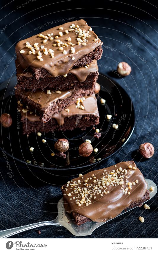 ..smells of hazelnut - piled up chocolate cake with a piece of cake on a cake shovel in front of a black background Cake Chocolate Cracknel Hazelnut
