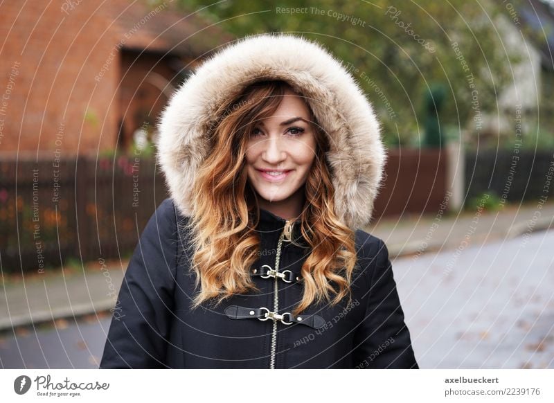smiling young woman wearing winter coat with fake for hood Lifestyle Style Winter Human being Feminine Young woman Youth (Young adults) Woman Adults 1