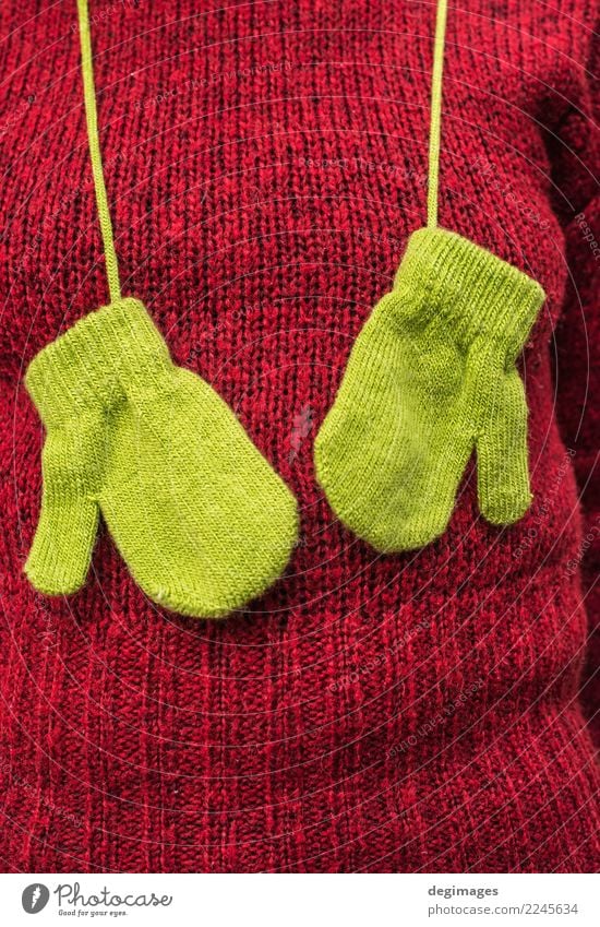 Winter green gloves on women red sweater Woman Adults Autumn Warmth Fashion Clothing Sweater Scarf Gloves Hat Natural Green Red Colour background Wool Seasons