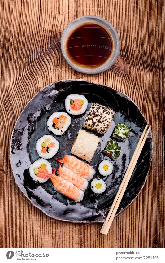 Sushi set on pottery plate with chopsticks and soy sauce Food Seafood Plate Table Wood Rust Fresh Delicious Above Tradition ceramic Chopstick Cooking Gourmet
