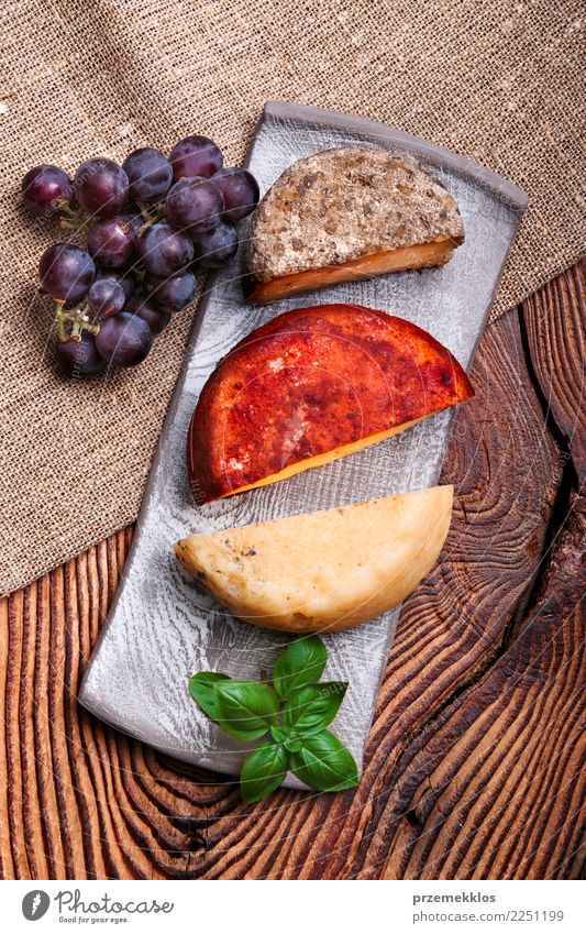 Cheese and black grapes on handmade pottery plate Food Dairy Products Fruit Plate Table Wood Rust Fresh Delicious Above ceramic Cooking Gourmet Bunch of grapes