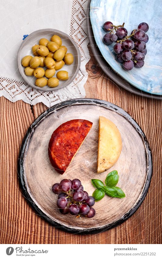 Cheese and black grapes on handmade pottery plate Food Fruit Nutrition Breakfast Plate Table Wood Rust Fresh Delicious Above ceramic Cooking Gourmet