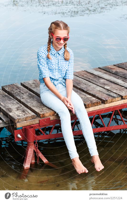 Girl sitting on jetty over the lake and dipping feet in water Lifestyle Joy Happy Relaxation Leisure and hobbies Vacation & Travel Summer Summer vacation