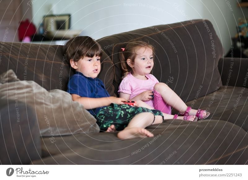 Two brothers playing video games at home. - a Royalty Free Stock Photo from  Photocase