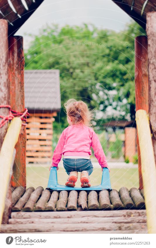 Little toddler girl playing in the playground standing on slide Joy Happy Summer Garden Child Toddler Girl Infancy 1 Human being 3 - 8 years Park Playground