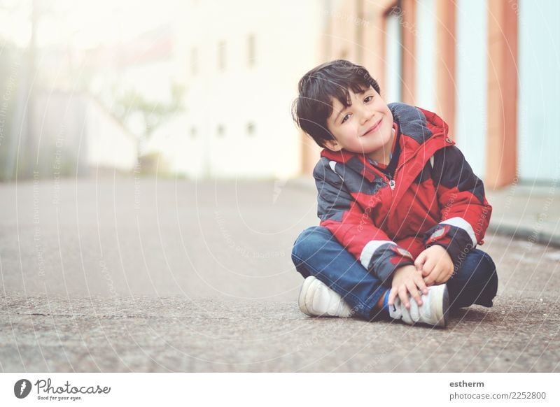 Happy boy sitting on the floor Lifestyle Joy Human being Masculine Child Baby Toddler Infancy 1 3 - 8 years Fitness Smiling Laughter Sit Friendliness Happiness
