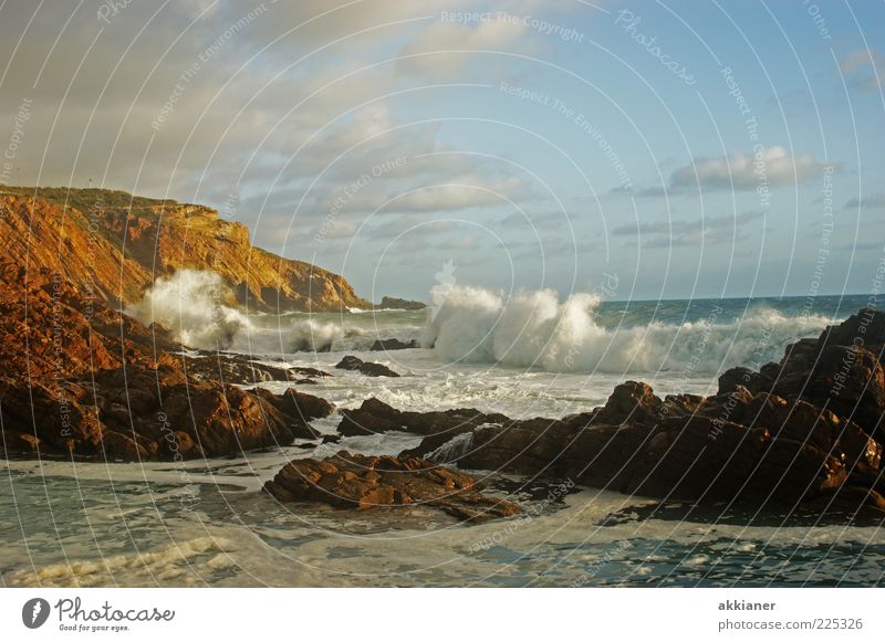 surf Environment Nature Landscape Sky Clouds Beautiful weather Waves Coast Ocean Bright Wet Natural Blue Brown Rock Swell White crest Stone Mountain Surf