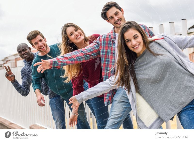Group of multi-ethnic young people having fun together outdoors in urban background Lifestyle Joy Happy Academic studies Human being Young woman