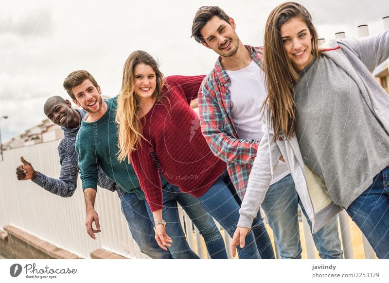 Group of multi-ethnic young people having fun together outdoors in urban background Lifestyle Joy Academic studies Human being Young woman Youth (Young adults)