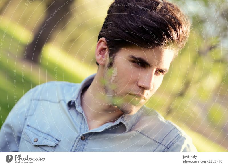 https://www.photocase.com/photos/2253710-young-man-with-modern-hairstyle-in-urban-park-photocase-stock-photo-large.jpeg