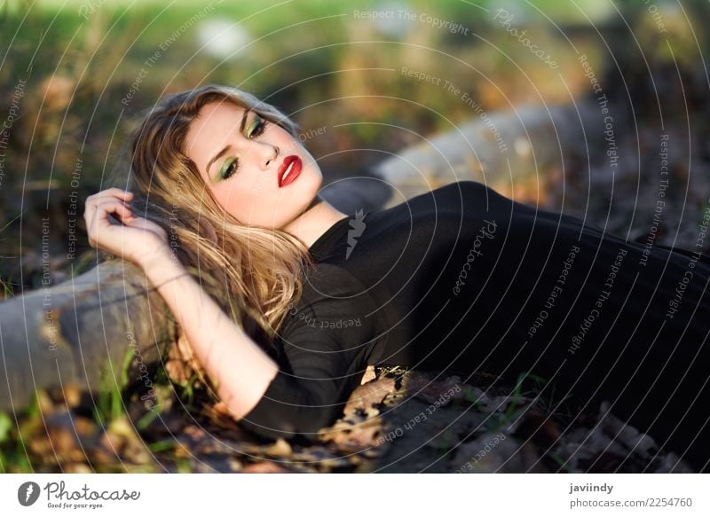 Relaxed girl lying on the field with long curly hair Beautiful Hair and hairstyles Face Make-up Human being Feminine Young woman Youth (Young adults) Woman