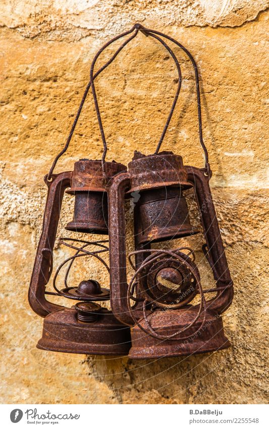 Two forgotten old lanterns hang together on the wall and remember old times. Day Deserted Exterior shot Colour photo Old Antique Oil lamp Lamp Lantern