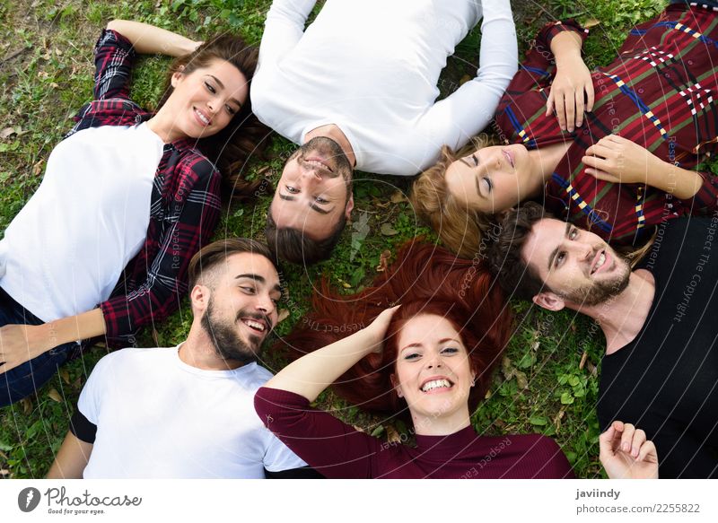 Women and men laying on grass wearing casual clothes. Lifestyle Joy Happy Beautiful Human being Masculine Feminine Young woman Youth (Young adults) Young man