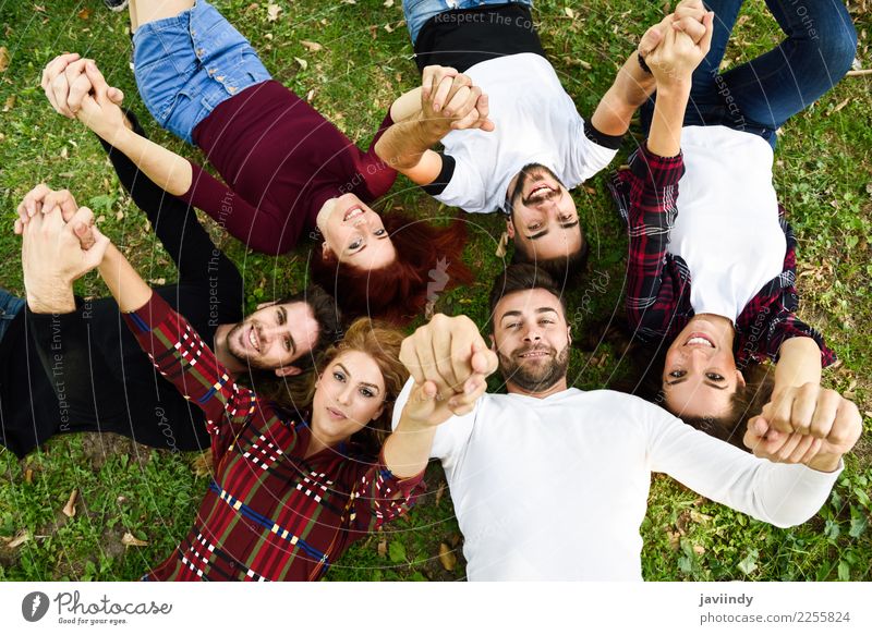 Women and men laying on grass wearing casual clothes. Lifestyle Joy Human being Masculine Feminine Young woman Youth (Young adults) Young man Woman Adults Man