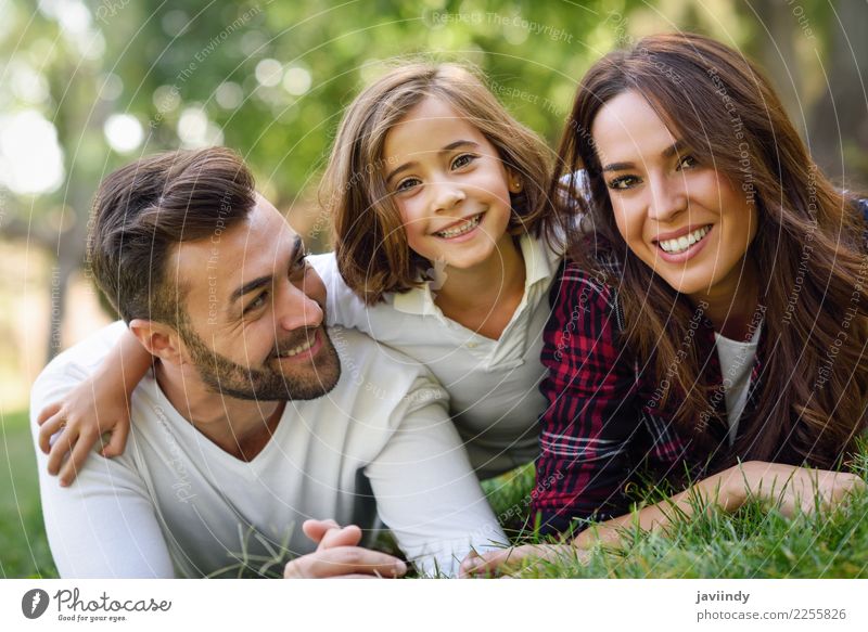 Father, mother and little daughter laying on grass. Lifestyle Joy Happy Beautiful Summer Child Human being Masculine Feminine Girl Young woman