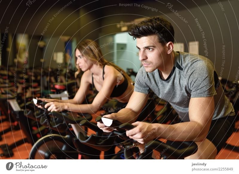 Couple in a spinning class wearing sportswear. Lifestyle Leisure and hobbies Sports Work and employment Human being Masculine Feminine Young woman
