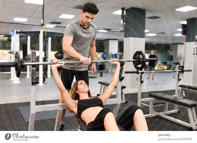 Personal trainer motivating a young woman lift weights Lifestyle Body Sports Human being Masculine Feminine Young woman Youth (Young adults) Young man Woman