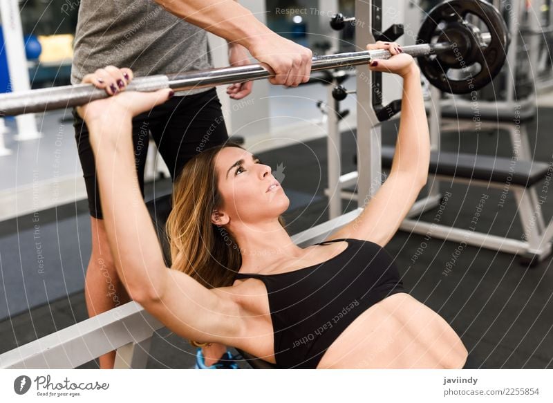 Personal trainer motivating a young woman lift weights Lifestyle Body Sports Human being Masculine Young woman Youth (Young adults) Young man Woman Adults Man 2