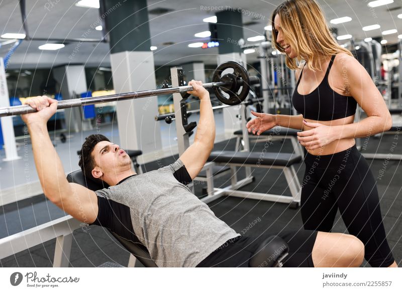 Man and woman personal trainers in the gym. Stock Photo by