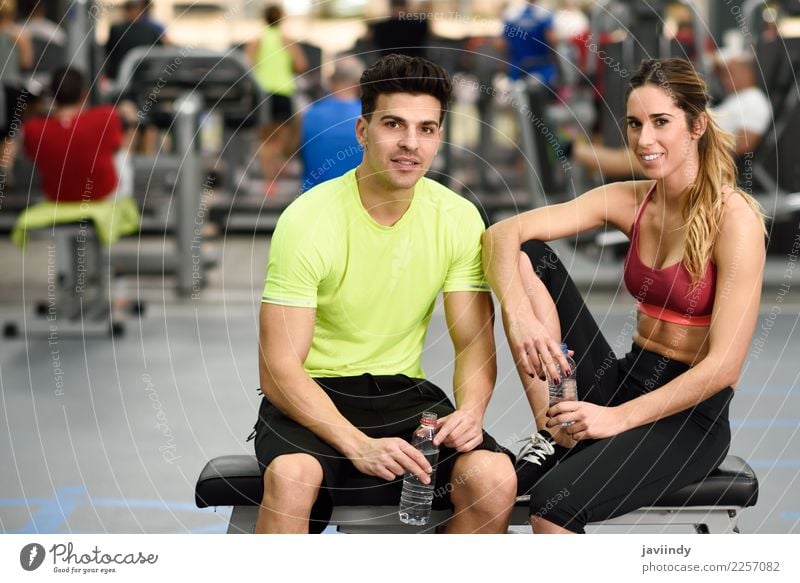 Man and woman personal trainers in the gym. Drinking Bottle Lifestyle Happy Body Wellness Sports To talk Human being Masculine Feminine Young woman